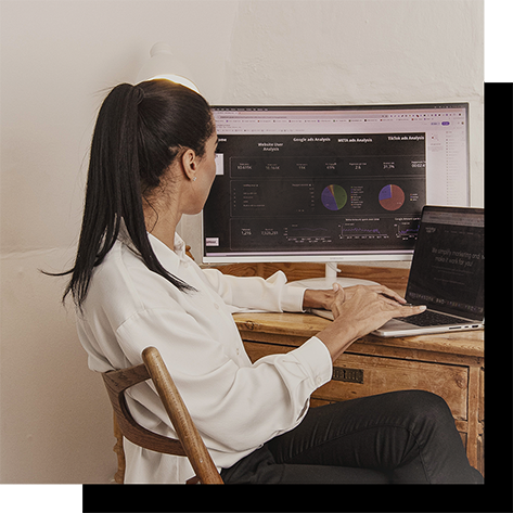 Woman analyzing marketing analytics dashboard on computer in modern workspace